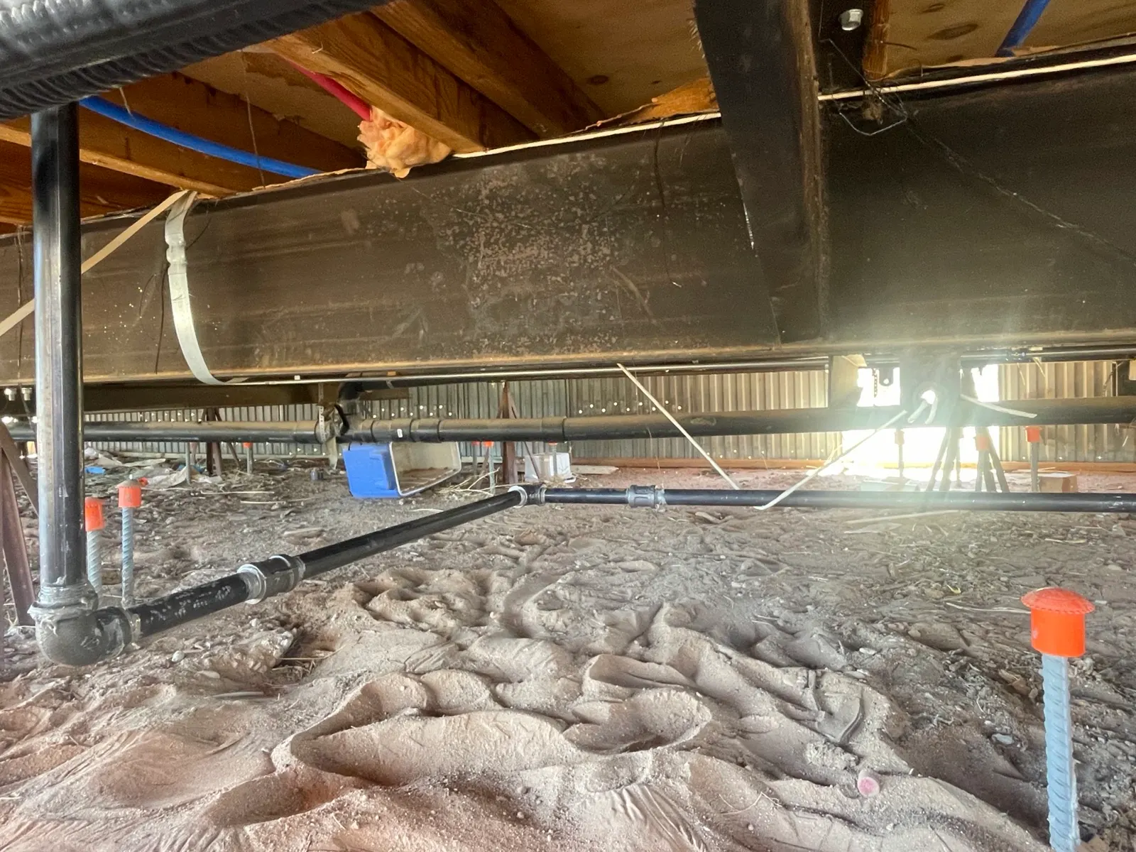 New black-iron gas piping run under a manufactured home in Marana, installed by Picture Rocks Cooling