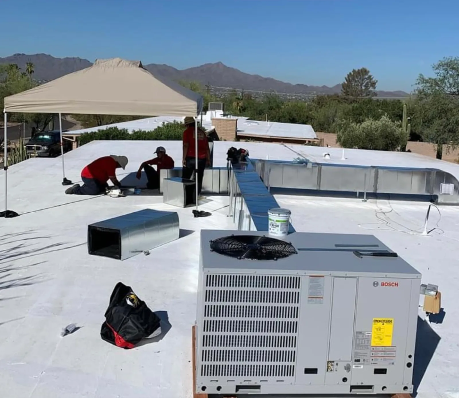 Picture Rocks crew installing ductwork on a Tucson rooftop.